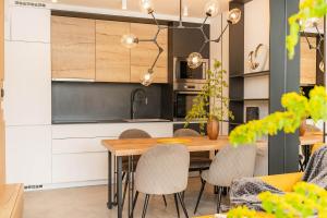 a kitchen with a wooden table and chairs at AMBER in Rabac