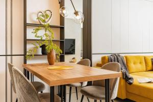 a dining room with a wooden table and chairs at AMBER in Rabac