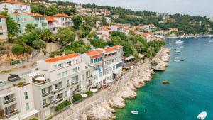 a group of buildings next to a body of water at AMBER in Rabac