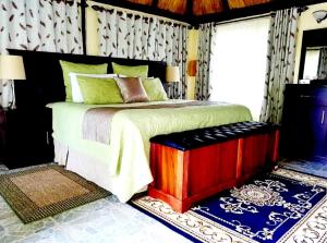 a bedroom with a large bed and a window at Art Lodges in Harare