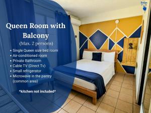 a room with a bed with blue and yellow walls at West Coast Inn's in Boqueron