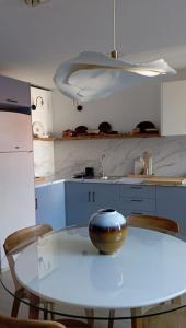 a white kitchen with a table and chairs in it at Apartamento da Torre in Guarda
