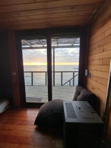 a room with a laptop on a couch in front of a window at Casa hermosa vista in Boca Pupuya