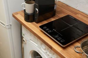 a tablet sitting on a counter next to a microwave at Warehouse flat East London in London