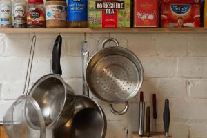 a bunch of pots and pans hanging on a kitchen counter at Warehouse flat East London in London