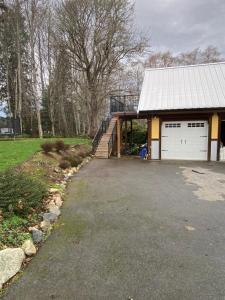 a house with a garage and a driveway at Seaside Perch in Sooke