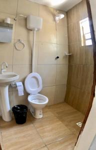 a bathroom with a toilet and a shower at Kitnet a 150m da praia in Rio Grande
