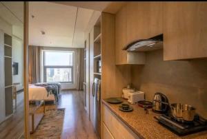 uma cozinha com um balcão e uma cama num quarto em Luxury Apartment In Gurgaon em Gurgaon