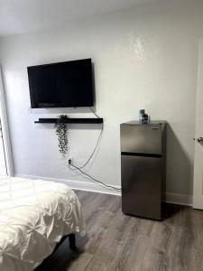 a room with a flat screen tv on a wall at Nice and Cozy guest house in Miami