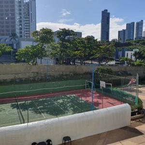 a tennis court in the middle of a city at Apartamento no Ondina Apart Hotel in Salvador