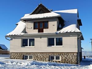 a house with snow on top of it at Kowolove in Bańska Wyżna