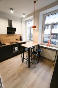 eine Küche mit einem Tisch und Stühlen im Zimmer in der Unterkunft Goethe-Suites: Premium 4 Person Worms city centre Appartment in Worms