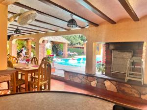 a patio with a fireplace and a table and chairs at Hotel Posada Andaluz in Xochitepec