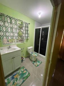 a small bathroom with a sink and a toilet at Zayne's comfort zone in Hayes