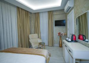 a hotel room with a bed and a chair at Luxury Medea Taksim Hotel in Istanbul