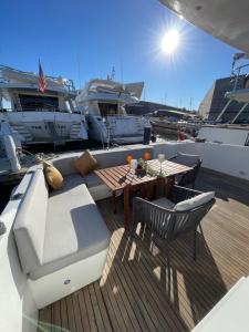a wooden deck with a table and chairs on a boat at Yate Hotel STV in Barcelona