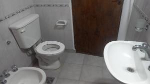 a bathroom with a toilet and a sink at Casa Familiar in Mar del Plata