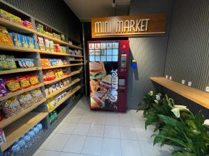 a grocery store aisle with a soda machine in a store at Link Araranguá in Araranguá