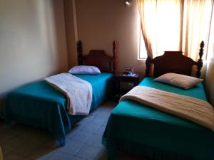 A bed or beds in a room at Hotel Tahami