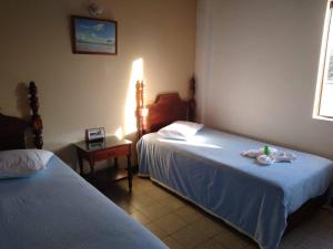 A bed or beds in a room at Hotel Tahami