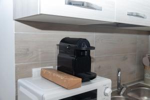 a black hair dryer sitting on top of a microwave at DOMVS Ginori Testaccio in Rome