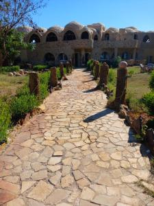 a stone path in front of a building at Oasis Panorama Hotel in Bawiti