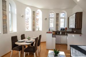 a kitchen and dining room with a table and chairs at Kula Centar in Trebinje