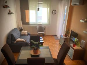 a living room with a couch and a table at Apartman “Zara” in Zagreb