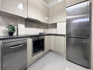 a kitchen with a stainless steel refrigerator and a dishwasher at Prometheus Apt in Piraeus