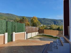 a building with a fence with a hedge at La Casa del Bosque in El Bosque