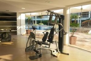 a gym with cardio equipment in a house at Apartamento vista mar resort in Florianópolis