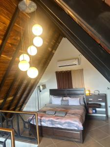 a bedroom with a large bed in a attic at Piece Of Heaven Cabins in Palmira