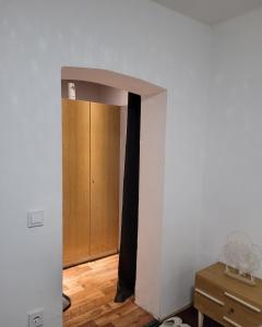 a hallway with a door and a wooden cabinet at Monteurzimmer/Ferienwohnung/Pension in Siegen +1 photo