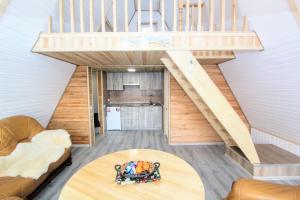 a staircase in a tiny house with a table at Cottage "A-FRAME romantic house" in Yaremche