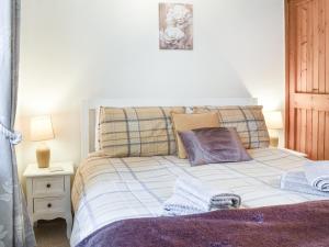 a bedroom with a bed with towels on it at West Kellet in Silecroft