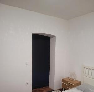 a bedroom with a black door on the wall at Monteurzimmer/Ferienwohnung/Pension in Siegen