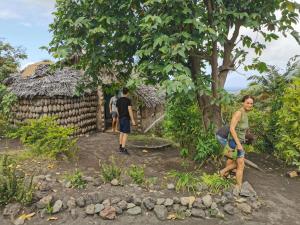 a group of people standing in front of a building at Tanna Lava View Bungalows in Lénakel