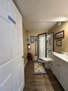 a bathroom with a shower and a toilet and a sink at Happy House - Regina City in Regina