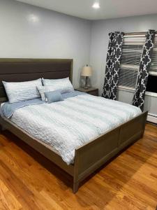 a bedroom with a large bed with a wooden floor at Fab 3 Bedroom 1Bath Apartment in NYC! in New York
