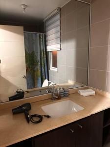 a bathroom with a sink and a mirror at Beautiful Confortable House in Estación Colina