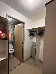 a small bathroom with a toilet and a shower at Beautiful Confortable House in Estación Colina