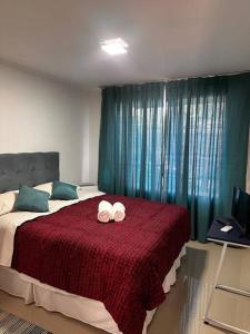 a bedroom with a bed with two towels on it at Beautiful Confortable House in Estación Colina