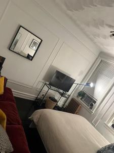 a bedroom with a bed and a flat screen tv at Two bedroom excellent location in Queens