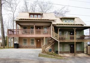 a large house with a porch and a balcony at The Dahlonega Square Hotel & Villas in Dahlonega