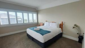 a bedroom with a large bed and a large window at Sky Stars Elegant Home with Seaview in Auckland +20 photos