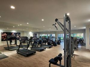 a gym with a bunch of treadmills and machines at Meridian Medini 2 双单床舒适环境齐全设备 in Nusajaya