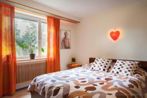 a bedroom with a bed with a red heart on the wall at Villa Berkle in Stockholm