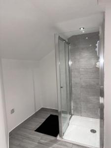 a bathroom with a shower with a glass door at 2 bed Apartment in Chapeltown in Roundhay