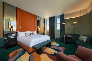 a bedroom with a bed and a living room at W New York - Union Square in New York