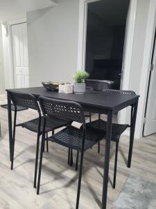 a black dining room table and chairs with a table at Covenant Properties in Edmonton